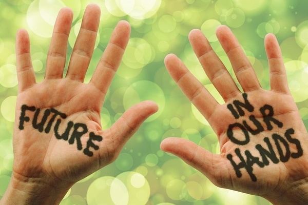 Zwei Hände vor grünem Hintergrund. Schwarze Schrift auf Handinnenflächen Zwei Hände vor grünem Hintergrund. Schwarze Schrift auf Handinnenflächen